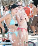She covers her firm breasts and soft pussy in sunscreen before lying down with her ass showing