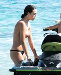 She covers her firm breasts and soft pussy in sunscreen before lying down with her ass showing