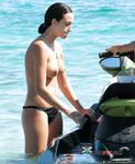 She covers her firm breasts and soft pussy in sunscreen before lying down with her ass showing