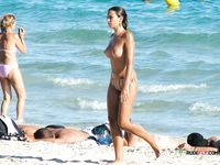 Younger and more mature ladies have fun at the beach topless, showing off their tits and curves