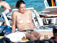 Pink Thong and White Headband Kneeling Beside the Shoreline