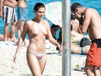 This young cutie shows off her pale, perky tits on a skinny frame while sitting down 2