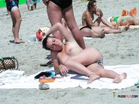 Hands on Her Hips, Topless on a Rocky Sunny Beach