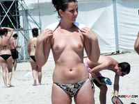 Hands on Her Hips, Topless on a Rocky Sunny Beach