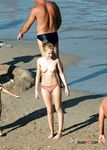 Topless Walk Across a Crowded Sandy Beach
