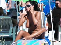 This breathtaking brunette lies down and sunbathes with her perfect, firm, natural breasts bouncing around freely