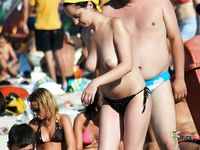 Sensual cutie sunbathes her trimmed pussy and her tiny tits while a skinny brunette sits around completely naked