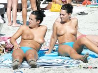 She lies in the sand on her stomach before turning around and giving the perfect view of her trimmed snatch