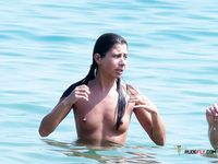 Clear Blue Water Frames Her Nude Walk Along the Beach