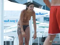 Topless Beach Moment Beneath Large White Umbrellas