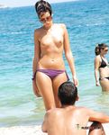 Purple Bikini Bottoms as She Meets the Rolling Beach Waves Topless
