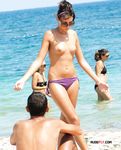 Purple Bikini Bottoms as She Meets the Rolling Beach Waves Topless