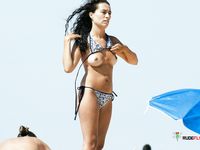 Naturist Confidence on a Walk Beside Clear Blue Beach Water