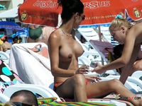 Delectable MILF enjoys being surrounded by older naked men in a nudist park while she wears nothing but her black thongs 2