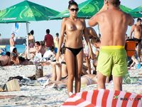 Delectable MILF enjoys being surrounded by older naked men in a nudist park while she wears nothing but her black thongs 2