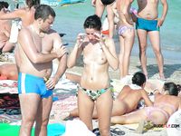 Attractive brunette chick with some juicy tits hangs out at the nudist camp