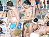 Attractive brunette chick with some juicy tits hangs out at the nudist camp