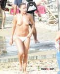 Tan Skin, Orange Bottoms, and Shoreline Calm at a Topless Beach