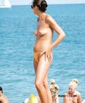 Tan Skin, Orange Bottoms, and Shoreline Calm at a Topless Beach