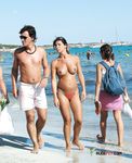 This nude beach girl sits down to sunbathe her curvaceous body and a pair of massive, supple, natural breasts