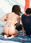 Nude Beach Walkers Follow the Sandy Path With Waves at Their Side