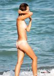 Some girls sit around topless while others swim around the water completely naked 3
