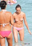 Silver Necklace Gleam on a Busy Topless Beach Smoke Break