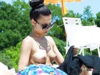 Besides her bikini panties, she's totally naked, and she's just enjoys the sun on her