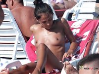 Pink Bikini Bottoms and Sunglasses on a Topless Beach Lounger