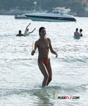 She swims in the sea topless before going back to the beach to sunbathe with her supple breasts on display 2