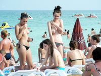 Playful nudist cuties have fun at the beach 2