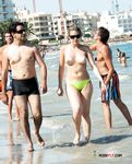 Chubby nudist mom is walking around the nudist camp while displaying her perfect tits and shave pussy while her family is having fun in the sea