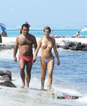 Playing Paddle Ball Topless in Shallow Sea Water