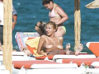 Hot redhead girl plays naked in the sand and arches her body, provoking all the men around her like she wants a whole nudist colony to fuck her 2