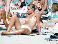 Her Topless Sunbathing Moment With Ocean Waves Behind