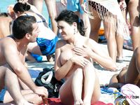 Her Topless Sunbathing Moment With Ocean Waves Behind