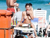 Two hot nudist chicks sunbathe their sexy asses at the beach 2