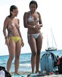 They come to a naked beach and then they enjoy themselves with her tits out, and you can see their asses as well