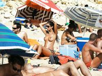 A sensual couple enjoys laying on the beach and having a sunbathe in a nudist camp 2