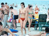 Colorful Beach Umbrella Behind a Topless Sunbather