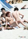 She poses and teases before being photographed with her perky tits and smooth, shaved pussy showing 2