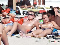 Nude Beach Moment Beside a Sandy Dune Slope
