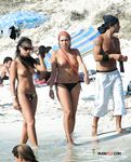 She gets secretly filmed sunbathing topless and showing off a pair of magnificent, large breasts
