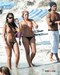 She gets secretly filmed sunbathing topless and showing off a pair of magnificent, large breasts