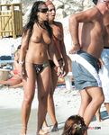 She gets secretly filmed sunbathing topless and showing off a pair of magnificent, large breasts