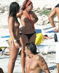 She gets secretly filmed sunbathing topless and showing off a pair of magnificent, large breasts