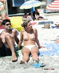 She gets secretly filmed sunbathing topless and showing off a pair of magnificent, large breasts