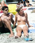 She gets secretly filmed sunbathing topless and showing off a pair of magnificent, large breasts