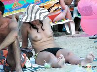 She covers her firm breasts and soft pussy in sunscreen before lying down with her ass showing 3