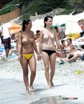 Ambiente abierto de playa junto a una mujer topless relajada